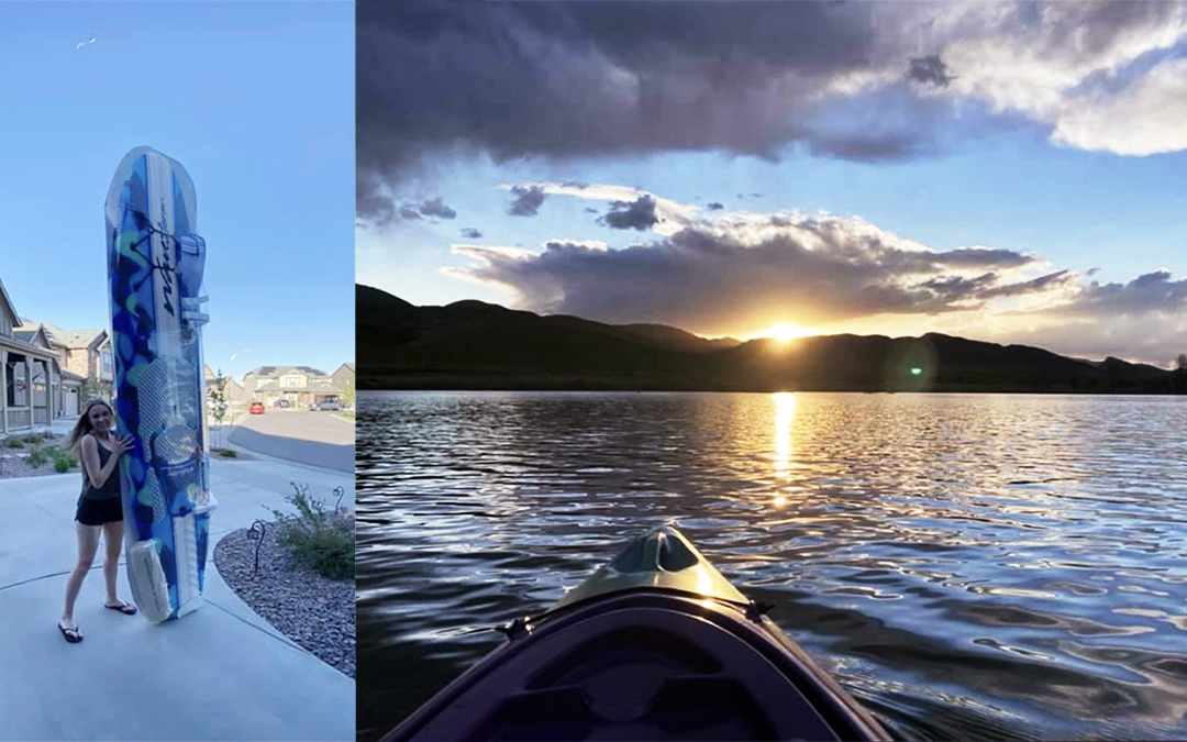A person stands on a driveway in Littleton, CO, holding a large wakeboard; next to it, a kayak floats on a lake at sunset with hills in the distance southwest of Denver.